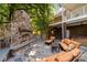 Outdoor patio with stone fireplace, hot tub, and comfortable seating at 721 Orphanage Rd, Concord, NC 28027