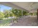 Screened porch overlooking a tranquil backyard and lake at 721 Orphanage Rd, Concord, NC 28027