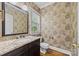 Elegant powder room featuring decorative wallpaper and a granite-topped vanity at 721 Orphanage Rd, Concord, NC 28027