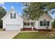 Charming single-story house with a white exterior and a two-car garage at 902 Snow Prince Ln, York, SC 29745