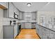 Modern kitchen with gray cabinets and granite countertops at 902 Snow Prince Ln, York, SC 29745