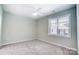 Bright bedroom featuring gray carpeting and a large window at 1517 28Th Street Se Pl, Hickory, NC 28602