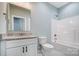 Modern bathroom with white vanity, granite countertop, and a shower/tub combo at 1523 28Th Street Se Pl, Hickory, NC 28602