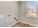 Laundry room with wood-look flooring and a window providing natural light at 1523 28Th Street Se Pl, Hickory, NC 28602