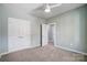 Well-lit bedroom with double doors and carpet flooring at 1529 28Th Street Se Pl, Hickory, NC 28602