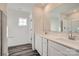 Bathroom with double vanity, white cabinets, and a large mirror at 1610 Cannonball Ln, Bessemer City, NC 28016