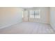 Spacious bedroom with gray carpeting and a window offering natural light at 1610 Cannonball Ln, Bessemer City, NC 28016