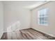 Bright bedroom with wood-look floors and a large window with blinds at 1610 Cannonball Ln, Bessemer City, NC 28016