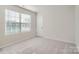 Spacious bedroom with gray carpet, a window with blinds, and an interior door at 1610 Cannonball Ln, Bessemer City, NC 28016