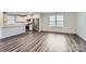 Modern kitchen with stainless steel appliances and gray wood-look floors at 1610 Cannonball Ln, Bessemer City, NC 28016