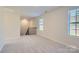 Open loft area with gray carpeting and two windows with blinds at 1610 Cannonball Ln, Bessemer City, NC 28016