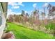 View of the grassy backyard and surrounding trees at 2866 15Th Avenue Se Pl, Hickory, NC 28602