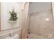 Well-maintained bathroom with a combination tub and shower, adorned with decorative accents for a touch of elegance at 715 Saint Cloud Dr, Statesville, NC 28625