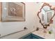 Powder room featuring blue wainscotting, sink with gold-trimmed mirror and decorative painting at 715 Saint Cloud Dr, Statesville, NC 28625
