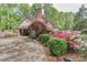 Charming brick home with landscaped front yard featuring mature trees, flowering bushes and paved driveway at 715 Saint Cloud Dr, Statesville, NC 28625