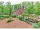 Well-maintained brick house showcasing lush landscaping, a brick walkway, mature trees and a serene backyard setting at 715 Saint Cloud Dr, Statesville, NC 28625