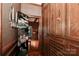 Hallway with wood parquet floor, wood-paneled walls, wood storage cabinets and drawers, and decorative screen at 715 Saint Cloud Dr, Statesville, NC 28625