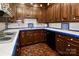 Galley kitchen featuring white tile countertops with blue accents, wood cabinets, and wood parquet floor at 715 Saint Cloud Dr, Statesville, NC 28625