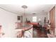 Upstairs landing with spiral staircase, parquet floors, white walls and vintage furnishings at 715 Saint Cloud Dr, Statesville, NC 28625