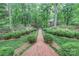 Beautifully landscaped brick pathway leading to a home surrounded by lush greenery at 715 Saint Cloud Dr, Statesville, NC 28625