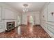 Spacious living room with fireplace, decorative molding, and exquisite hardwood floors at 715 Saint Cloud Dr, Statesville, NC 28625