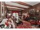 Elegant wood-paneled living room featuring a fireplace, beamed ceiling, and red accent decor at 715 Saint Cloud Dr, Statesville, NC 28625