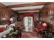 Elegant wood-paneled living room featuring a beamed ceiling and red accent decor at 715 Saint Cloud Dr, Statesville, NC 28625