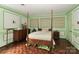 Charming main bedroom with four-poster bed, hardwood floors, and neutral decor that creates a cozy and inviting retreat at 715 Saint Cloud Dr, Statesville, NC 28625