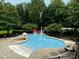 Community pool with spray features and plenty of lounge chairs at 1801 Briarcrest Dr, Charlotte, NC 28269