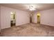 Large bedroom featuring striped wallpaper, dual windows, carpet and an ensuite bath at 370 21St Nw Ave, Hickory, NC 28601