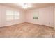 Well-lit bedroom featuring dual windows and carpeted flooring at 370 21St Nw Ave, Hickory, NC 28601