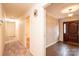 Hallway featuring brown tiled floors leading into a room with floral wallpaper at 370 21St Nw Ave, Hickory, NC 28601
