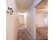 Hallway featuring tan carpeting with doorways leading to rooms at 370 21St Nw Ave, Hickory, NC 28601