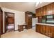 Kitchen area leading to bedroom, desk area, linoleum floors, floral wallpaper at 370 21St Nw Ave, Hickory, NC 28601