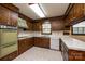 Retro kitchen with wood cabinets, white countertops, and vintage appliances at 370 21St Nw Ave, Hickory, NC 28601