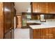 Spacious kitchen with wood cabinets, white counter tops and floral wallpaper at 370 21St Nw Ave, Hickory, NC 28601