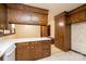 Kitchen featuring wooden cabinetry, linoleum flooring and decorative wallpaper accents at 370 21St Nw Ave, Hickory, NC 28601