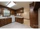 Functional kitchen with wooden cabinetry, a sink under the window, and views to dining area at 370 21St Nw Ave, Hickory, NC 28601
