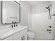 This bathroom has a black framed mirror and updated fixtures and finishes at 117 Hatford Ct, Statesville, NC 28625