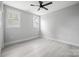 Well-lit bedroom featuring two windows, light wood flooring and neutral paint at 117 Hatford Ct, Statesville, NC 28625