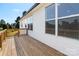 Exterior view of a stained wooden deck, white siding, and views of the backyard trees beyond at 117 Hatford Ct, Statesville, NC 28625