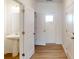 Bright bathroom featuring a pedestal sink and a classic white door at 4061 Lawnview Dr, Charlotte, NC 28269