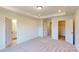 Spacious carpeted bedroom featuring a tray ceiling, an open closet, and ensuite bathroom at 4061 Lawnview Dr, Charlotte, NC 28269