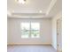 Bright bedroom with large window, plush carpet, tray ceiling, and recessed lighting at 4061 Lawnview Dr, Charlotte, NC 28269
