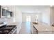 Open kitchen with granite countertops, stainless appliances, and an island overlooking the living area at 4061 Lawnview Dr, Charlotte, NC 28269