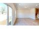 Open living room with sliding doors, light-colored floors, and staircase access at 4061 Lawnview Dr, Charlotte, NC 28269