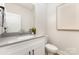 Powder room featuring granite countertop, chrome faucet, white cabinetry, and decorative wall art at 171 Heartland Dr # 7, Rock Hill, SC 29732