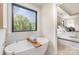 A modern bathroom boasts a soaking tub near a sunny window and is open to the bedroom at 171 Heartland Dr # 7, Rock Hill, SC 29732
