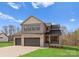 Beautiful two-story home featuring stone accents, three-car garage, covered porch, and manicured lawn at 171 Heartland Dr # 7, Rock Hill, SC 29732