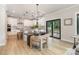 Open concept kitchen with modern light fixture, stainless steel appliances, island with seating, and backyard views at 171 Heartland Dr # 7, Rock Hill, SC 29732
